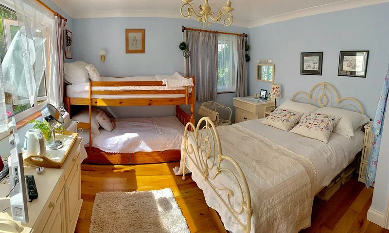 Family bedroom with a double bed and two bunk beds