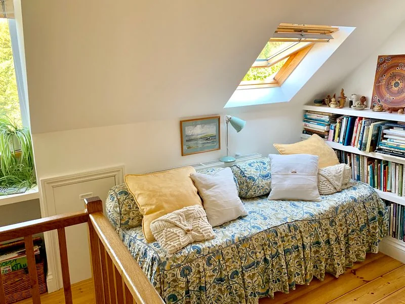 Landing seating area with a day bed beneath the roof windows